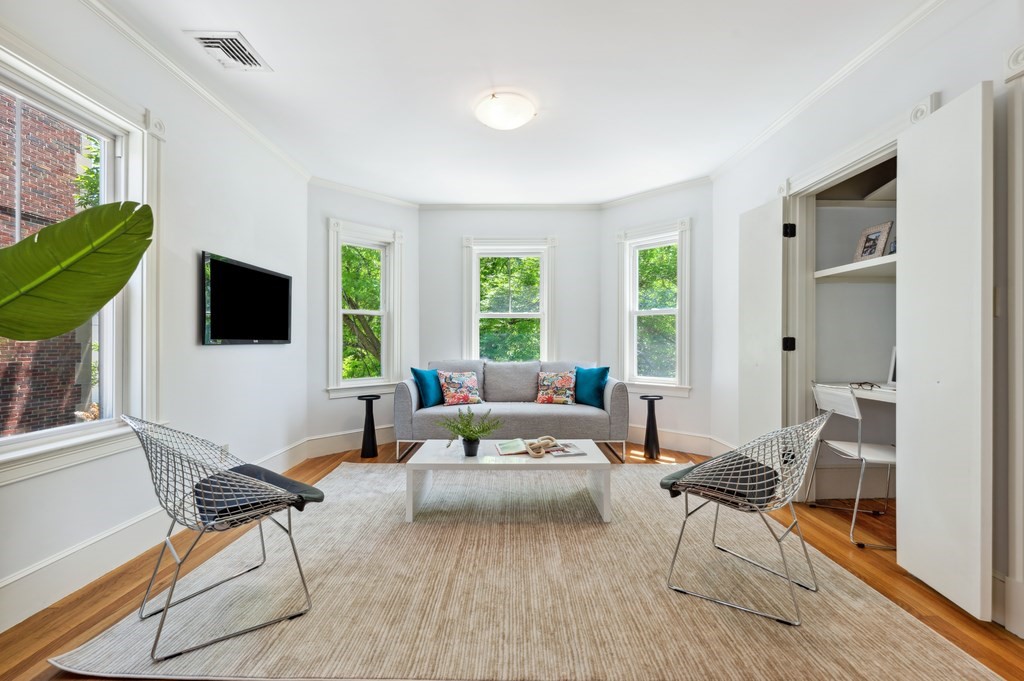 7 Haskell Street, Unit B Cambridge, MA 02140 - Photo 2 of 23 a living room with furniture a flat screen tv and a large window