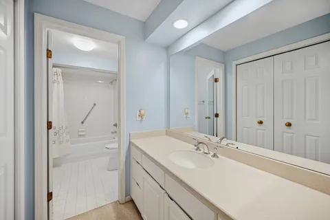 a bathroom with a sink a mirror and a vanity