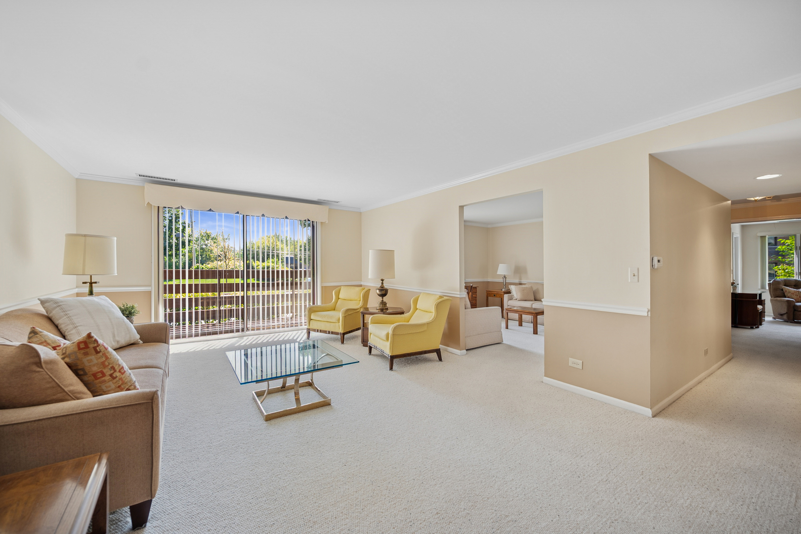 2000 Chestnut Avenue, Unit 103 Glenview, IL 60025 - Photo 7 of 27 a living room with furniture and a large window with balcony view
