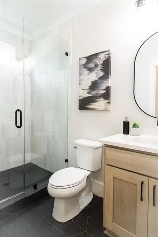 a bedroom with a bed a mirror and a window