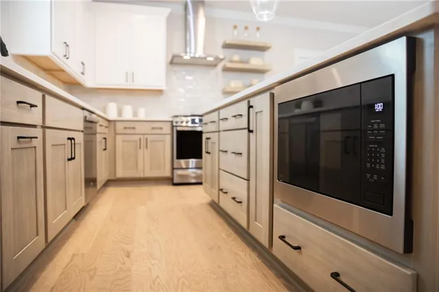 a kitchen with a sink a center island cabinets and a refrigerator