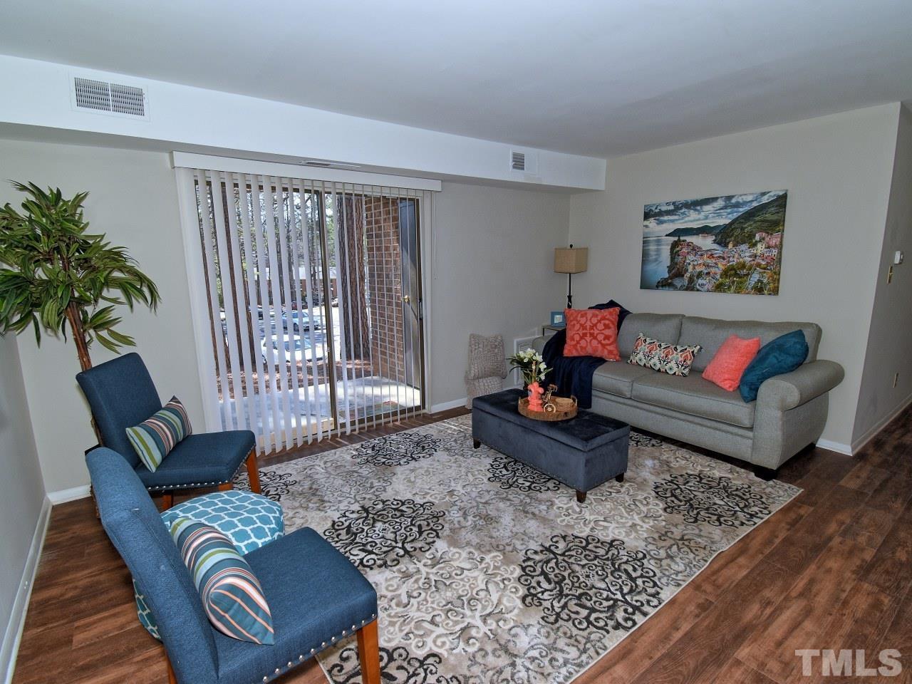 a living room with furniture and a rug
