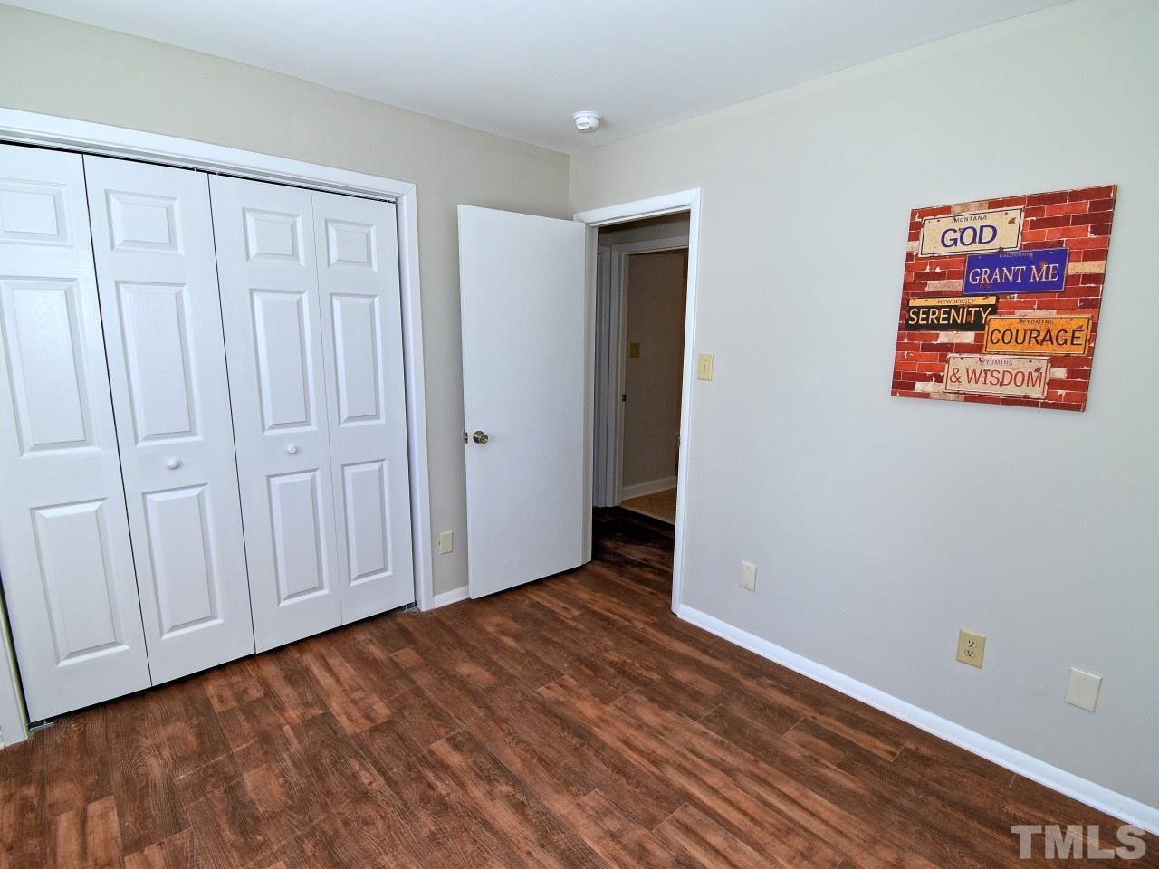 1000 Sandlin Place, Unit A Raleigh, NC 27606 - Photo 11 of 17 a view of an empty room with wooden floor