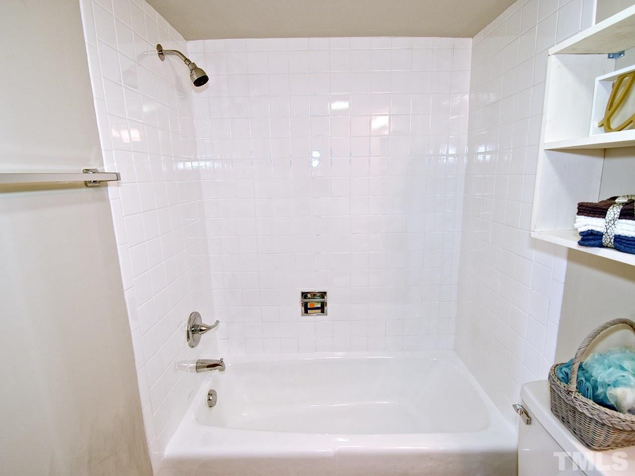 1000 Sandlin Place, Unit A Raleigh, NC 27606 - Photo 13 of 17 a bathroom with a bathtub and a window