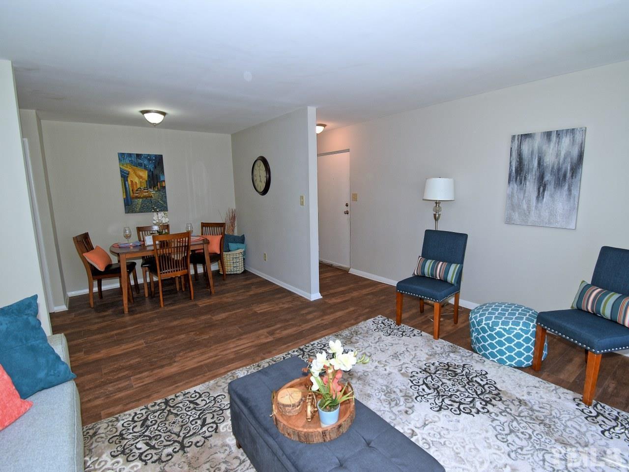 1000 Sandlin Place, Unit A Raleigh, NC 27606 - Photo 3 of 17 a living room with furniture a rug and a table