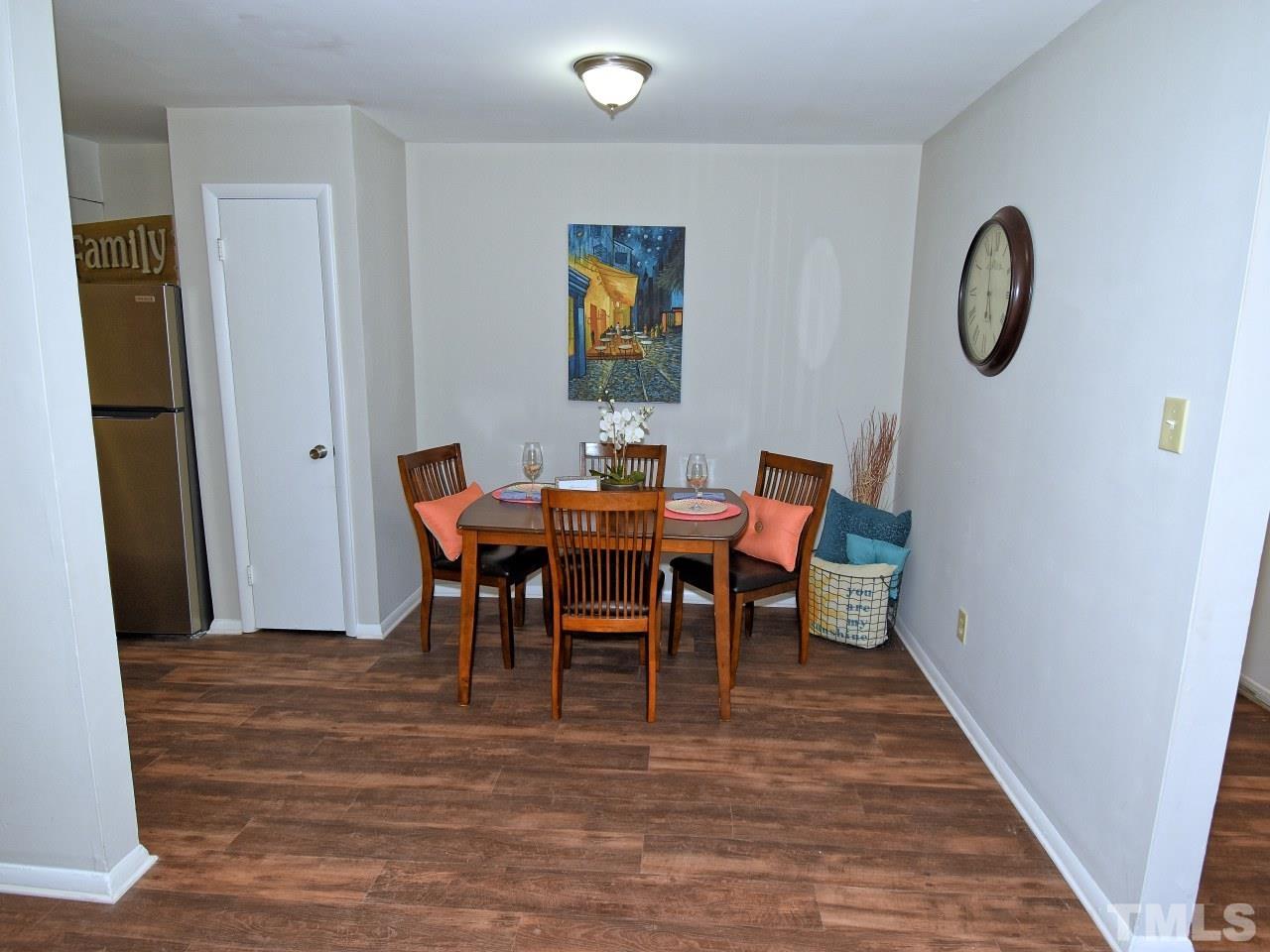 1000 Sandlin Place, Unit A Raleigh, NC 27606 - Photo 4 of 17 a dining room with furniture a rug and a mirror