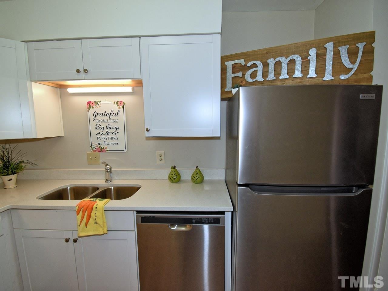 1000 Sandlin Place, Unit A Raleigh, NC 27606 - Photo 7 of 17 a kitchen with a refrigerator and a sink