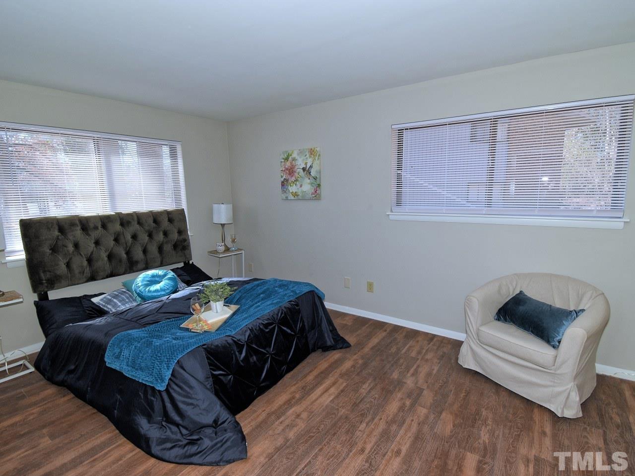 1000 Sandlin Place, Unit A Raleigh, NC 27606 - Photo 8 of 17 a bedroom with a bed and a couch