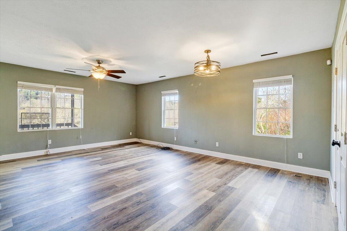 602 River Road Madison Heights, VA 24572 - Photo 9 of 24 a view of an empty room with a window and wooden floor
