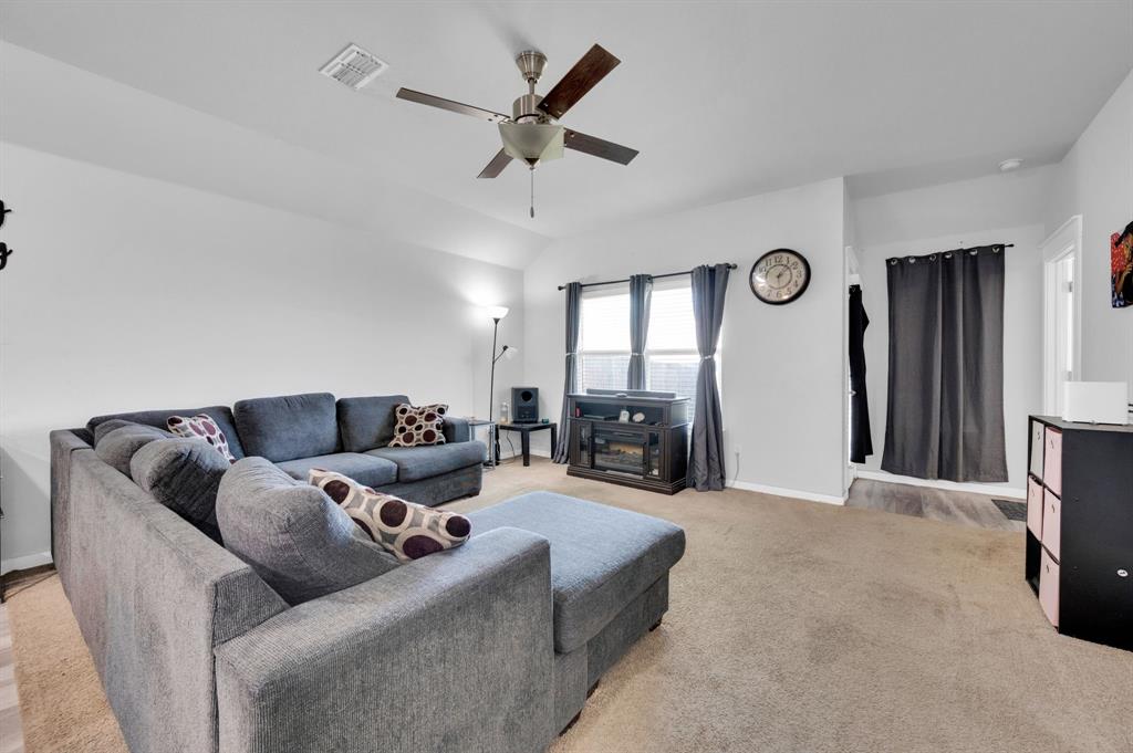 2609 Centurion Road Glenn Heights, TX 75154 - Photo 11 of 29 Living room featuring a ceiling fan, light colored carpet, and vaulted ceiling