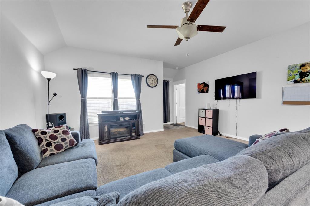 2609 Centurion Road Glenn Heights, TX 75154 - Photo 12 of 29 Carpeted living area with vaulted ceiling, a ceiling fan, and a glass covered fireplace