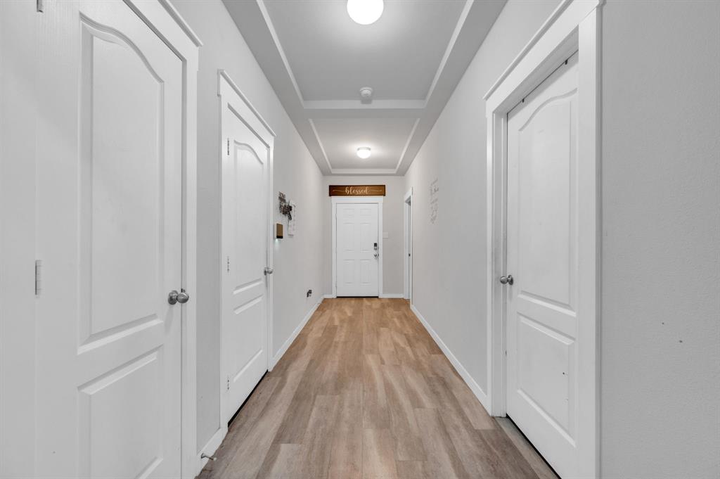 2609 Centurion Road Glenn Heights, TX 75154 - Photo 13 of 29 Hallway with light wood-style flooring and a raised ceiling
