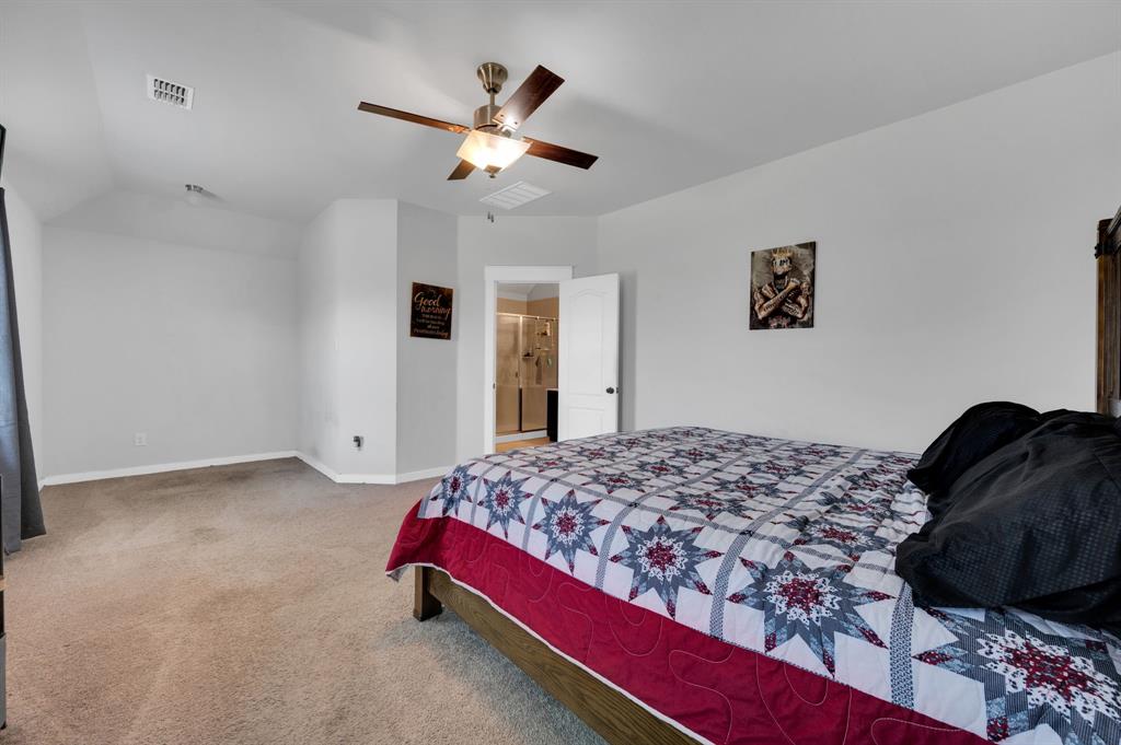 2609 Centurion Road Glenn Heights, TX 75154 - Photo 14 of 29 Bedroom featuring light carpet, ceiling fan, and ensuite bath