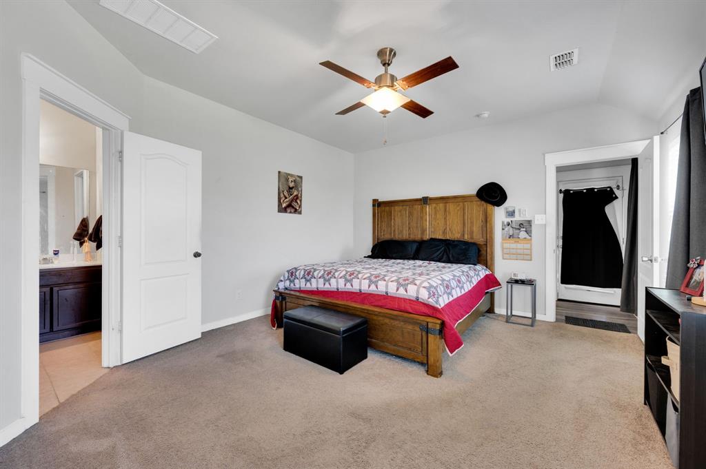 2609 Centurion Road Glenn Heights, TX 75154 - Photo 15 of 29 Bedroom with light colored carpet, lofted ceiling, a ceiling fan, and connected bathroom
