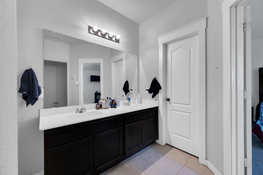 2609 Centurion Road Glenn Heights, TX 75154 - Photo 18 of 29 Bathroom with double vanity and light tile patterned flooring