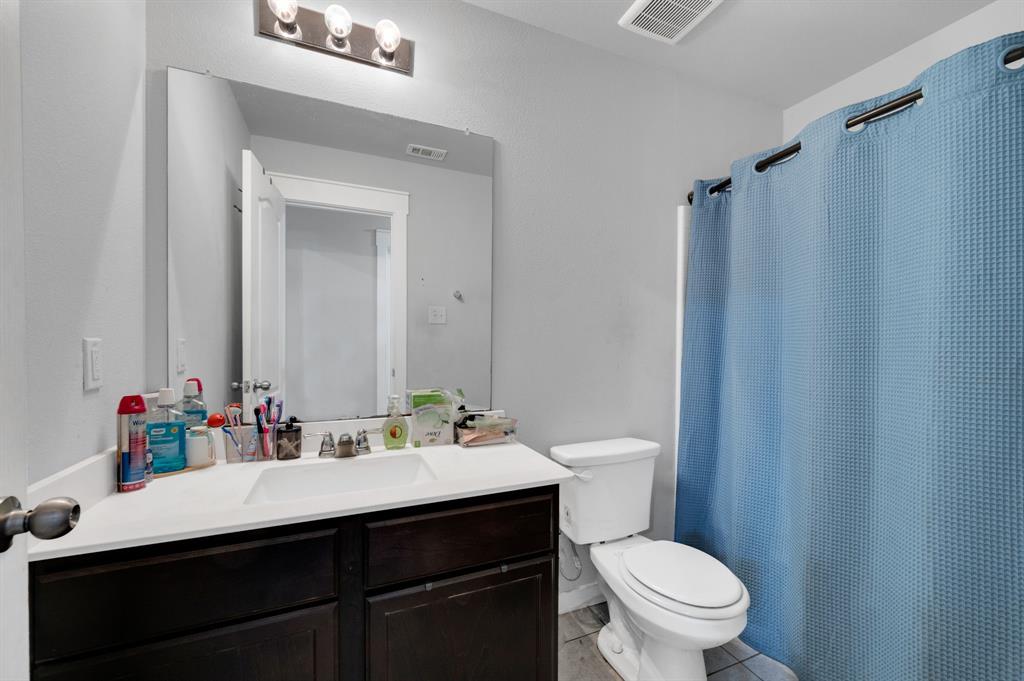 2609 Centurion Road Glenn Heights, TX 75154 - Photo 23 of 29 Full bathroom featuring vanity, a shower with curtain, and light tile patterned floors