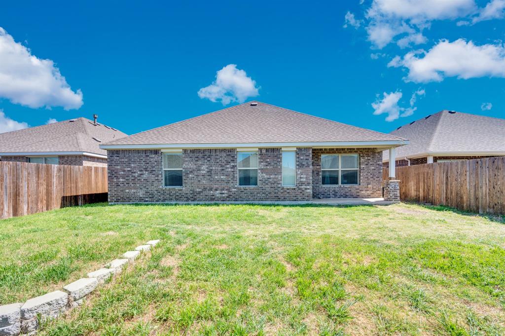 2609 Centurion Road Glenn Heights, TX 75154 - Photo 25 of 29 Rear view of property featuring a fenced backyard, brick siding, a patio, and a shingled roof