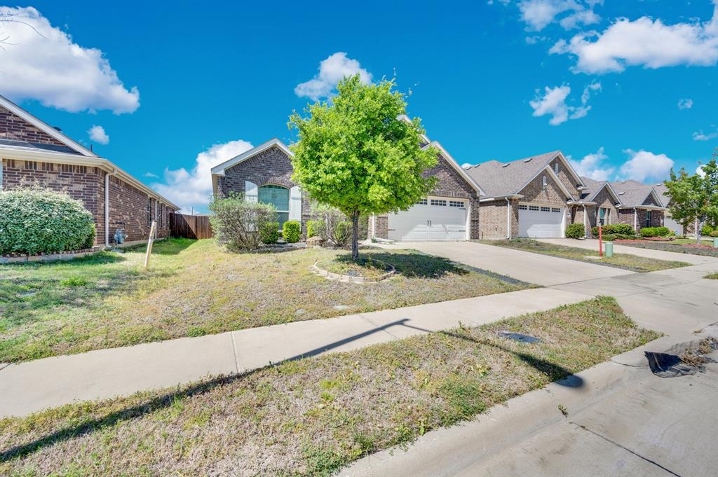 2609 Centurion Road Glenn Heights, TX 75154 - Photo 4 of 29 View of front of home with concrete driveway, a residential view, a garage, and brick siding
