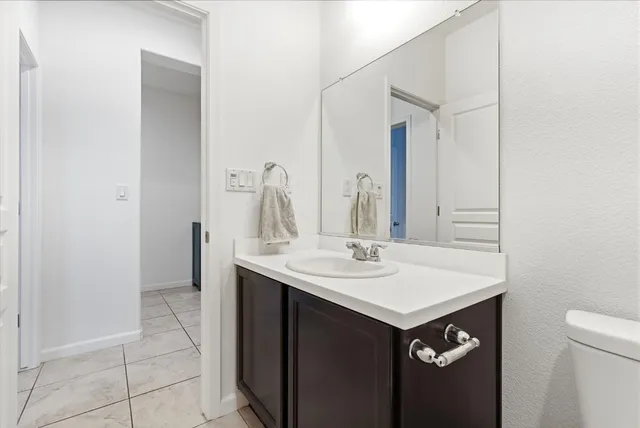 a utility room with a sink and a mirror