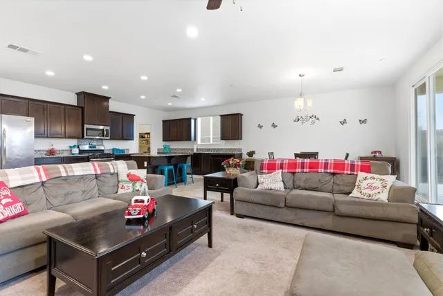 a living room with furniture and kitchen view