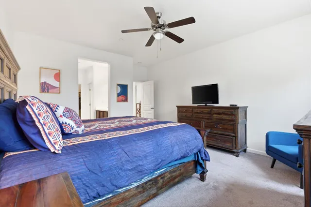 a bedroom with a bed and a television