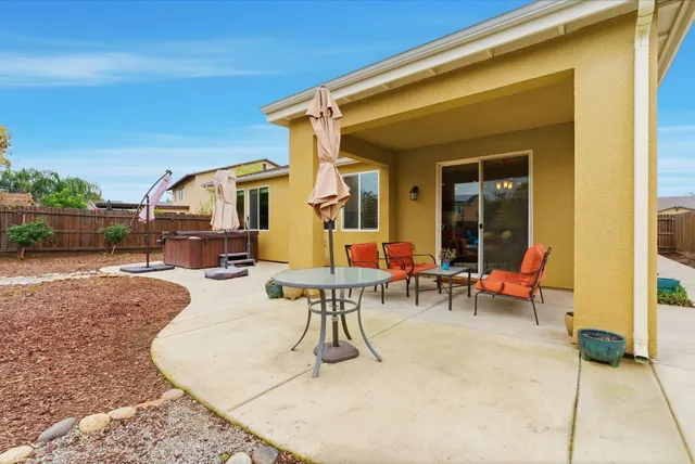 a view of a patio with a table and chairs