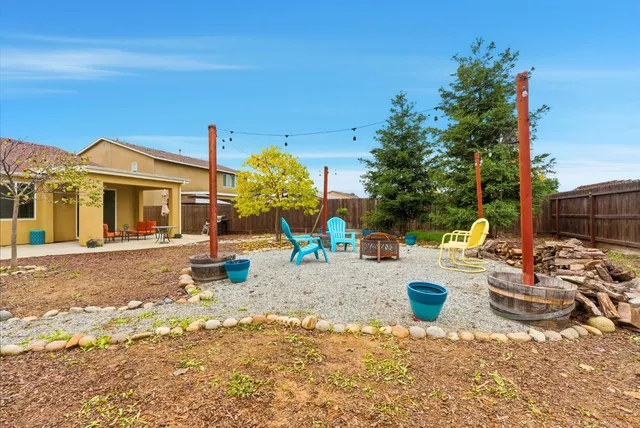 a view of a chair and tables in the patio