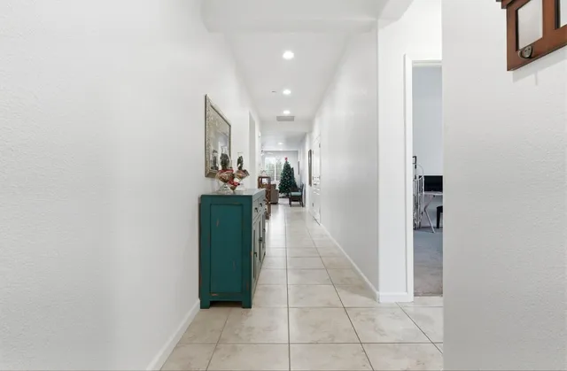 a hallway with a sink and a mirror
