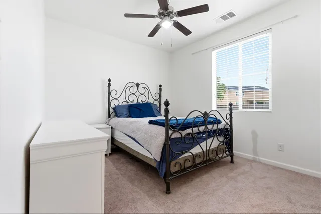 a bed sitting in a bedroom next to a window