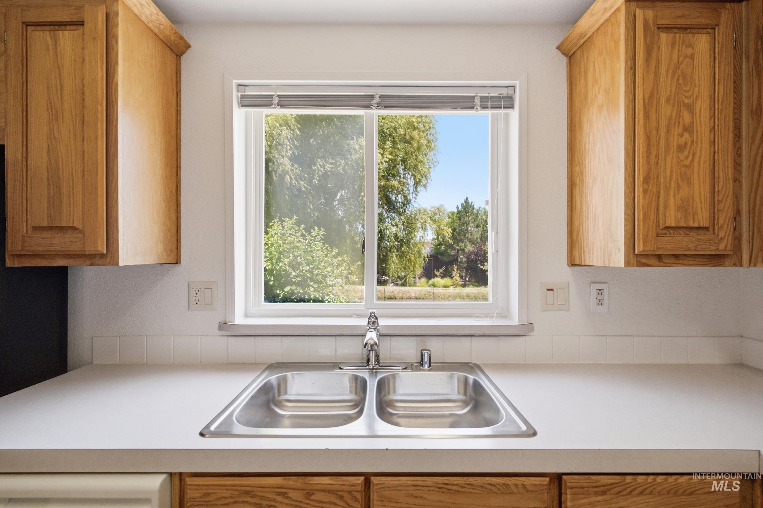 7422 Track Road Nampa, ID 83686 - Photo 8 of 50 Kitchen sink with a dual basin, chrome faucet, and a large window above