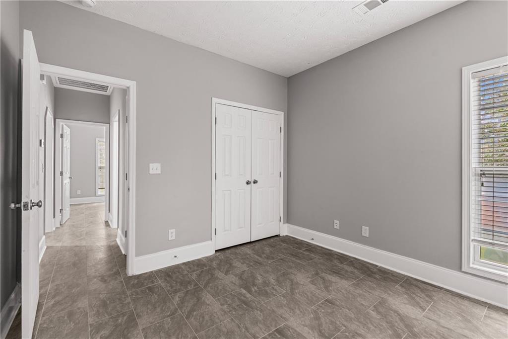 1449 Cummings Road Smiths Station, AL 36877 - Photo 12 of 28 Room featuring tile flooring, neutral wall paint, and white trim