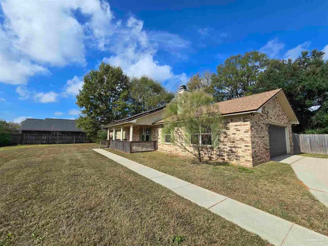 a view of a house with a yard