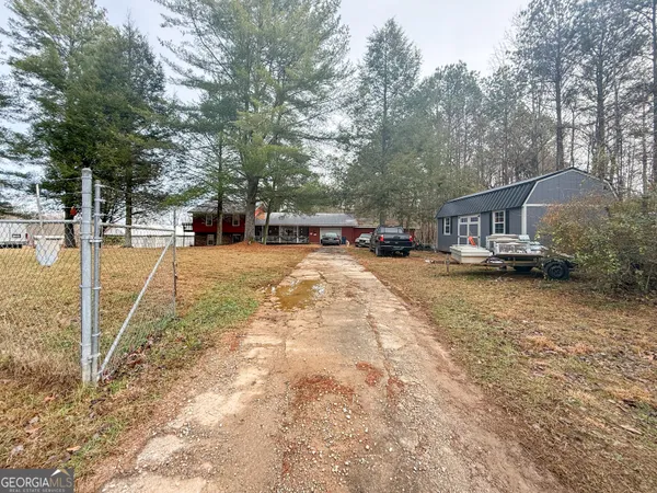 a view of a yard with cars
