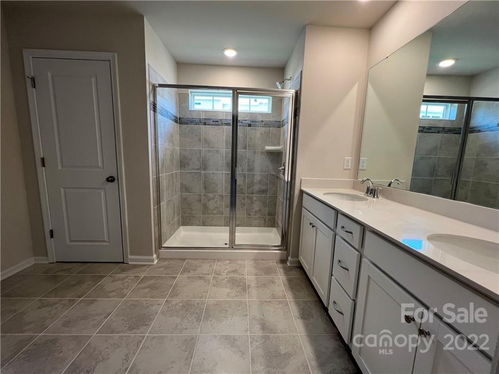 904 Pk Bnd Trail, Unit 71 Tega Cay, SC 29708 - Photo 14 of 14 a bathroom with double vanity and a shower