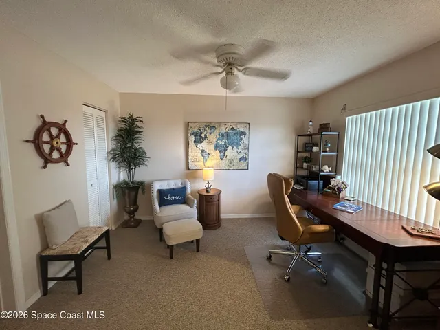a view of a livingroom with workspace and a couch