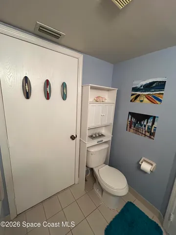 a white toilet sitting next to a shower curtain