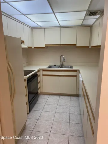 a kitchen with stainless steel appliances granite countertop a sink a stove a refrigerator and cabinets