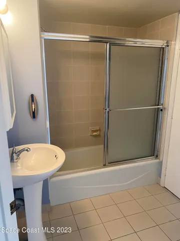 a bathroom with a shower and a sink