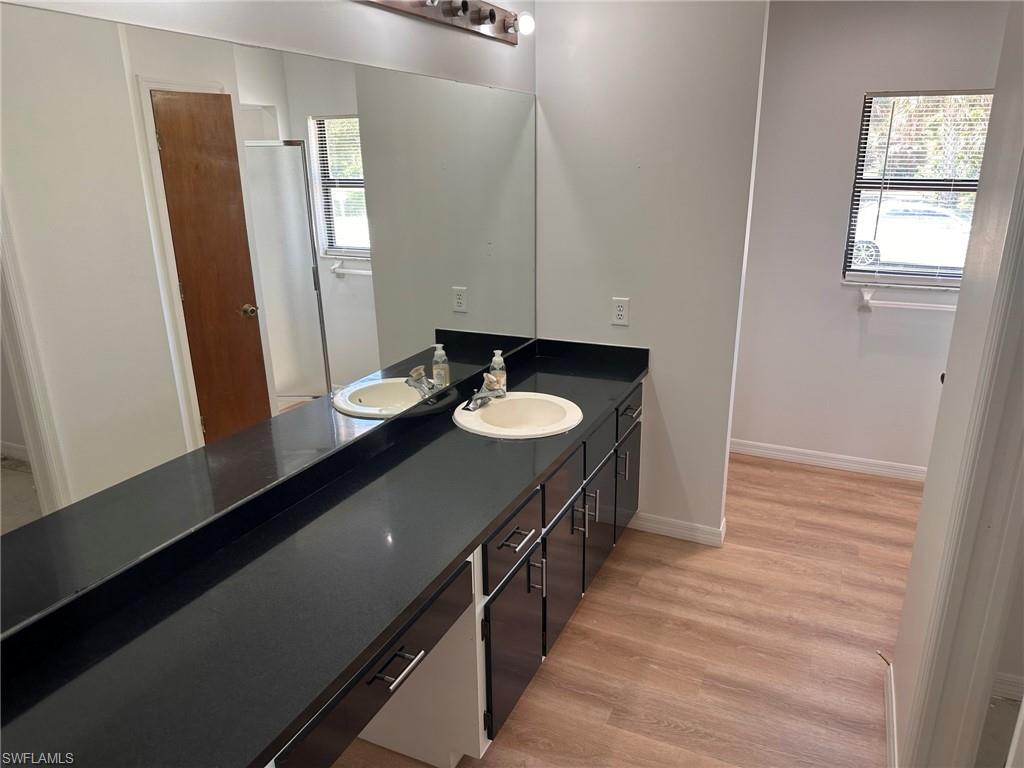 18475 Evergreen Road Fort Myers, FL 33967 - Photo 12 of 30 a bathroom with a sink a mirror and shower
