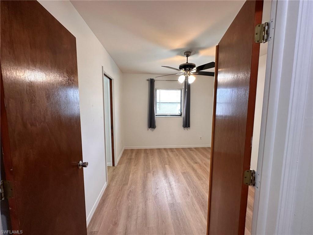 18475 Evergreen Road Fort Myers, FL 33967 - Photo 16 of 30 a view of a room with wooden floor closet and windows