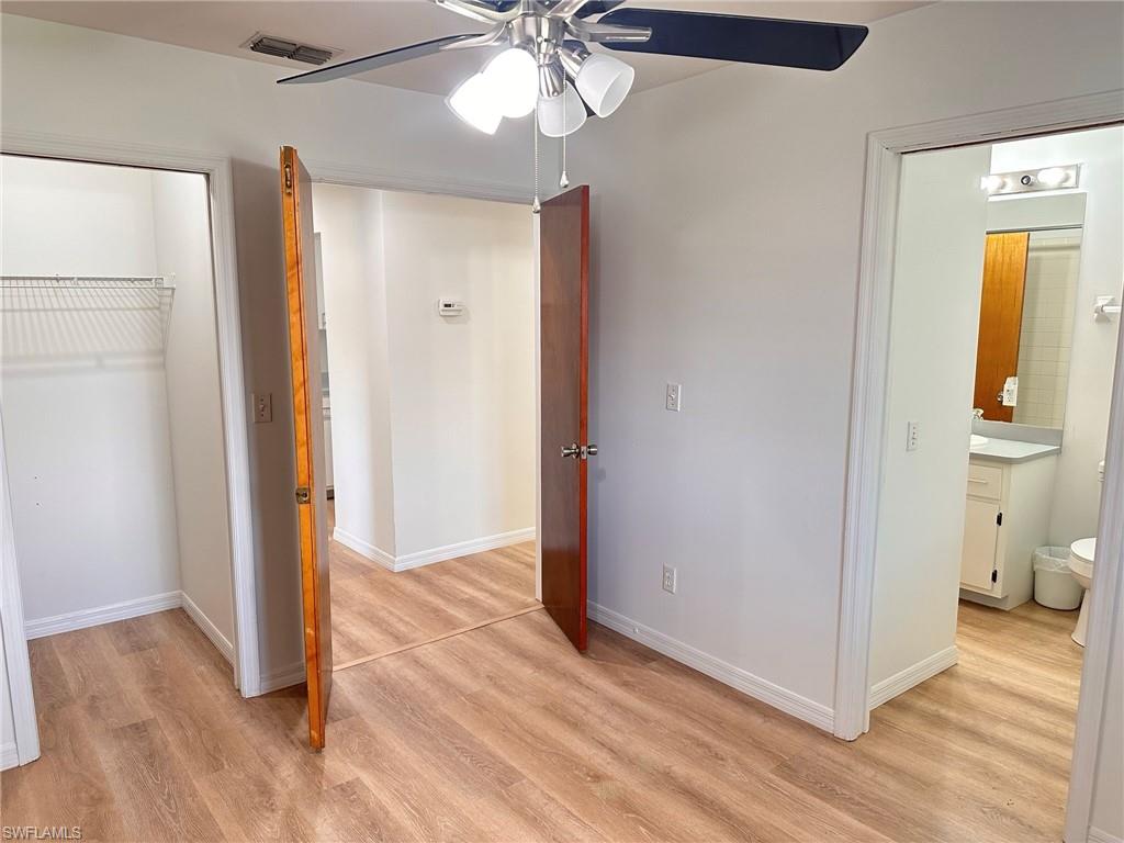 18475 Evergreen Road Fort Myers, FL 33967 - Photo 17 of 30 a view of a room with wooden floor and a ceiling fan