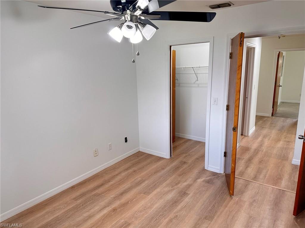 18475 Evergreen Road Fort Myers, FL 33967 - Photo 18 of 30 wooden floor in an empty room with a window