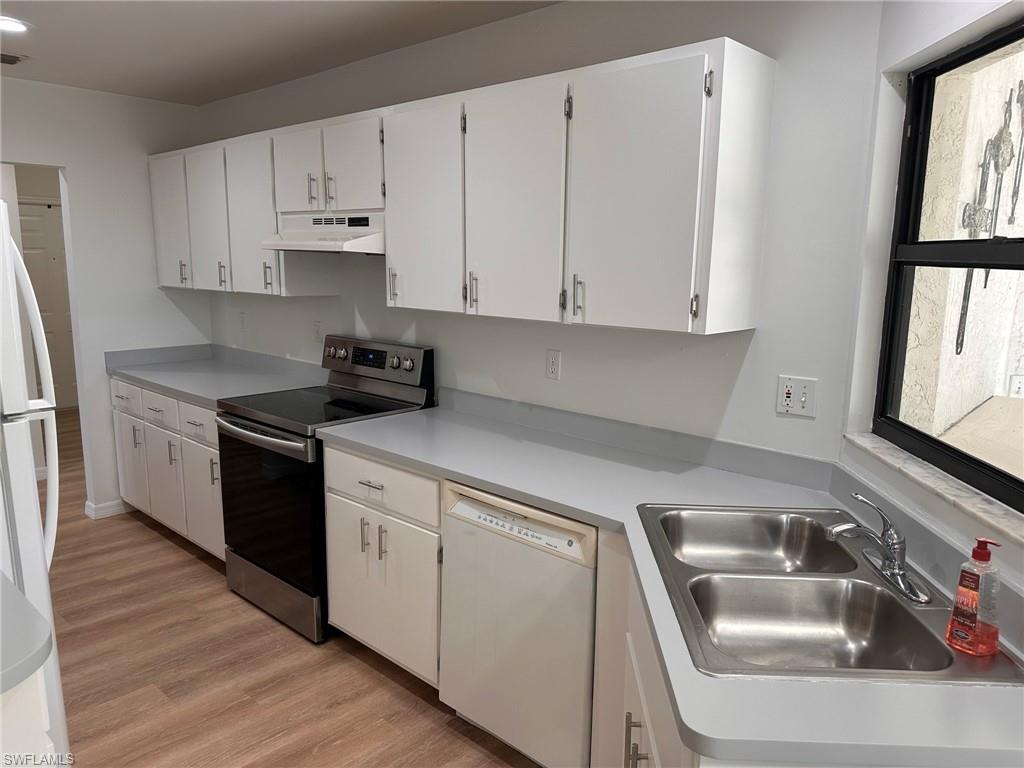 18475 Evergreen Road Fort Myers, FL 33967 - Photo 3 of 30 a kitchen with granite countertop white cabinets and a sink