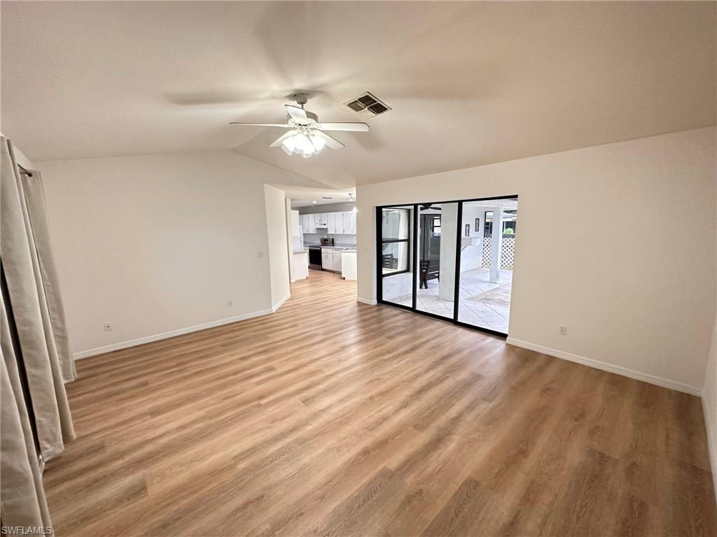 18475 Evergreen Road Fort Myers, FL 33967 - Photo 9 of 30 a view of an empty room with wooden floor and a window