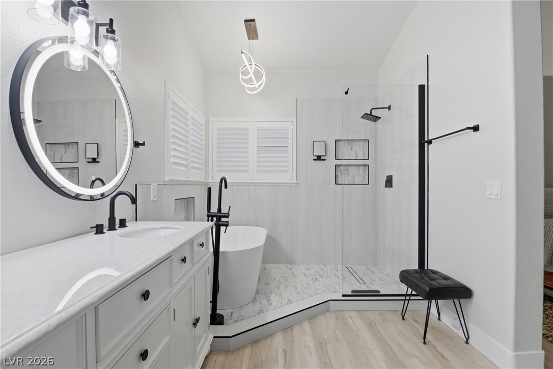 239 Highgate Street Henderson, NV 89074 - Photo 1 of 44 Retreat to a spa-inspired primary suite featuring a soaking tub, a beautifully tiled walk-in shower, dual vanities with upgraded countertops, & a spacious walk-in closet.