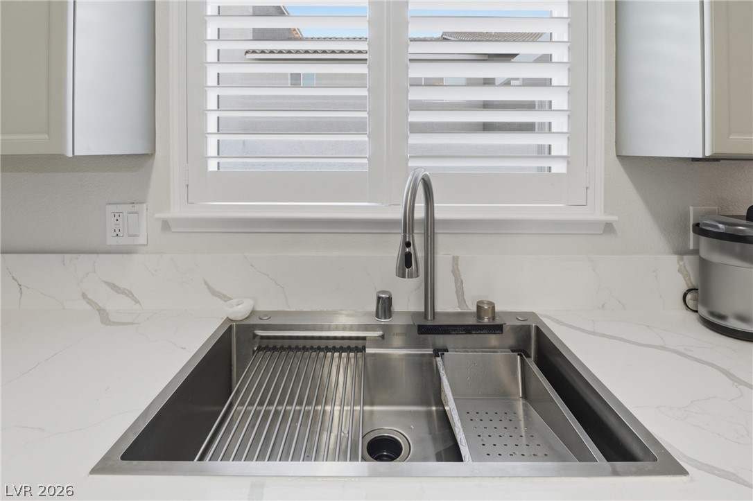 239 Highgate Street Henderson, NV 89074 - Photo 11 of 44 The chef’s kitchen is anchored by top-of-the-line stainless steel appliances, stunning quartz countertops, & striking custom cabinetry with designer hardware.