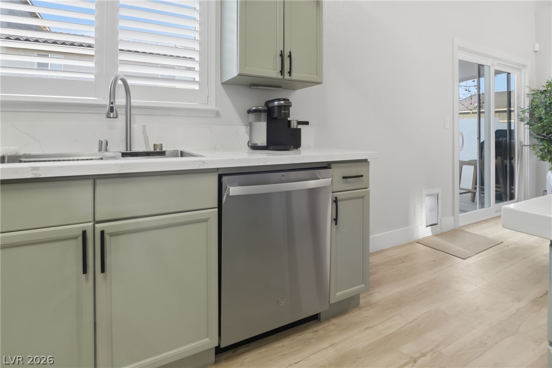 239 Highgate Street Henderson, NV 89074 - Photo 12 of 44 The chef’s kitchen is anchored by top-of-the-line stainless steel appliances, stunning quartz countertops, & striking custom cabinetry with designer hardware.