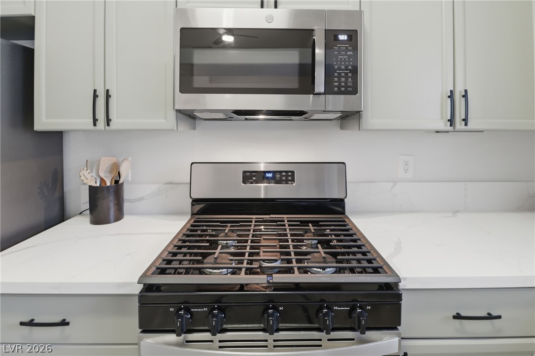 239 Highgate Street Henderson, NV 89074 - Photo 13 of 44 The chef’s kitchen is anchored by top-of-the-line stainless steel appliances, stunning quartz countertops, & striking custom cabinetry with designer hardware.