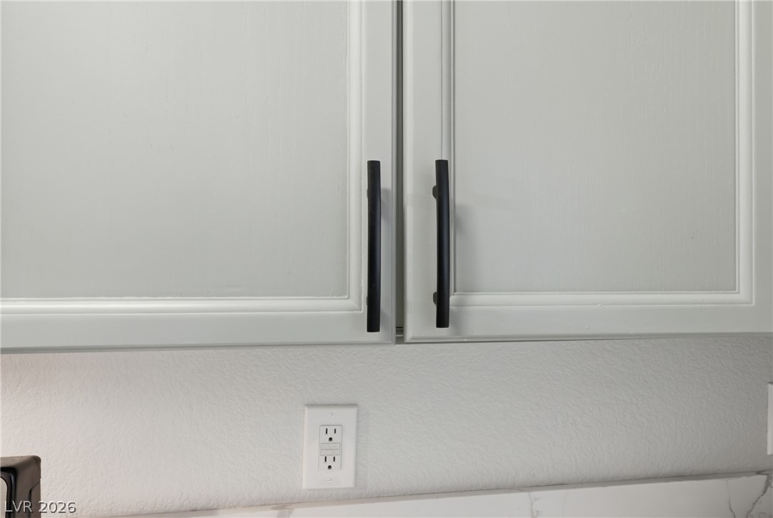 239 Highgate Street Henderson, NV 89074 - Photo 14 of 44 The chef’s kitchen is anchored by top-of-the-line stainless steel appliances, stunning quartz countertops, & striking custom cabinetry with designer hardware.