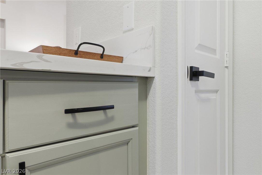 239 Highgate Street Henderson, NV 89074 - Photo 15 of 44 The chef’s kitchen is anchored by top-of-the-line stainless steel appliances, stunning quartz countertops, & striking custom cabinetry with designer hardware.